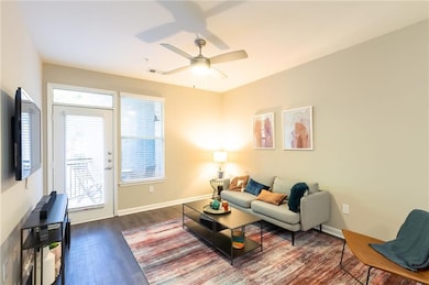 Living room with hardwood / wood-style flooring an