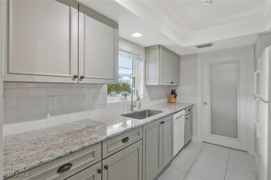 Kitchen featuring a tray ceiling, wood cabinetry,
