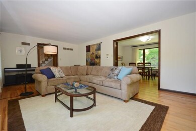 Large, bright living room with gleaming hardwood f