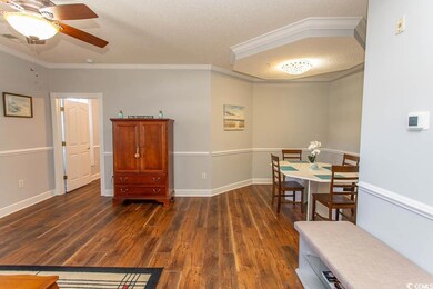 Dining room featuring crown molding, a textured ce