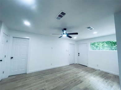 Empty room featuring light wood-type flooring, ceiling fan, and recessed lighting