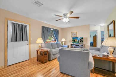 Living room with light hardwood / wood-style floor