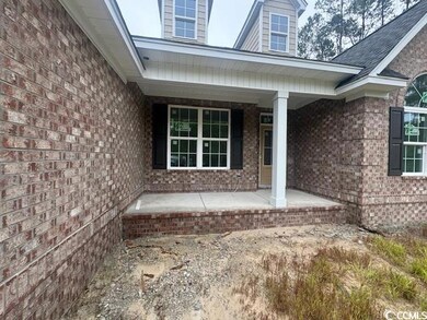 Entrance to property featuring a porch and brick siding