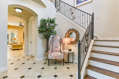 Stairway featuring ceiling fan, arched walkways, 