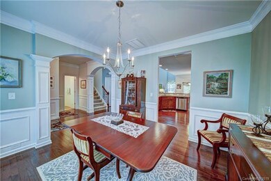 Formal dining room with hardwood floors and open t