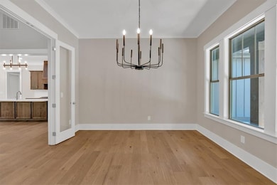 Dining room with tray ceiling, chandelier and rece