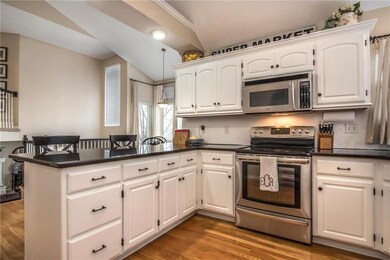 Abundant white cabinetry and a full tile backsplas