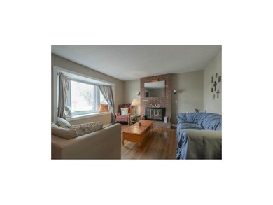 Living room with large bay window and fireplace.