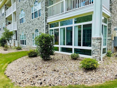 View of property exterior with stone siding and a 