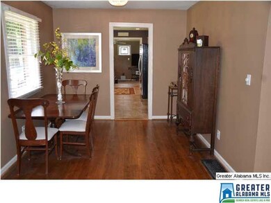 Formal dining area with hardwood floors and a larg