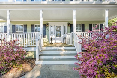 View of exterior entry with a porch