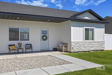 Property entrance with stone siding and a lawn
