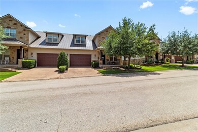 View of front of home with driveway, a metal roof,