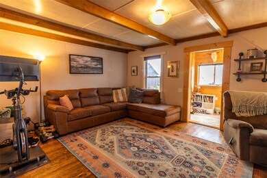 Living room with hardwood / wood-style flooring an