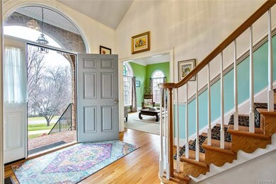 Foyer view into the formal living room and stairwa