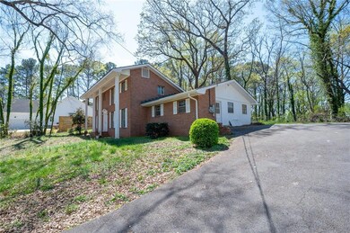 View of side of home featuring brick siding and ap