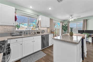 Kitchen featuring stainless steel appliances, dark