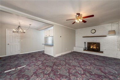 Living Room with wood burning fireplace and dining