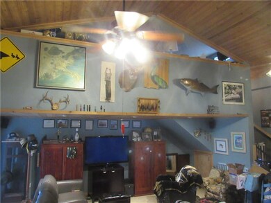 Den with unique ceiling and loft.