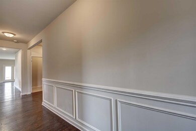 Spacious, Elegant entrance with wainscoting.  All photos of a similar home, not of the listed property.