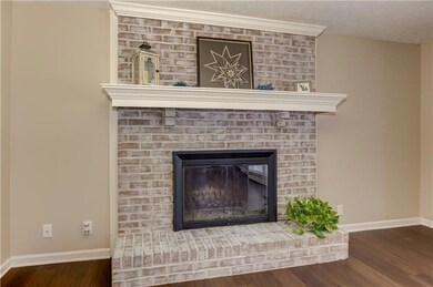 Detailed view of wood finished floors and a fireplace