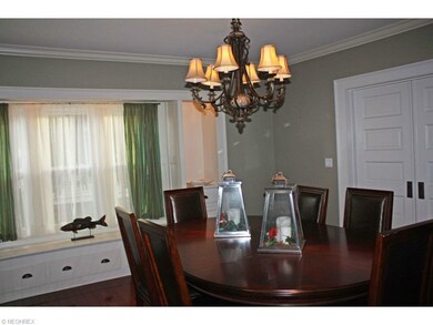 Dining Room With Gleaming Wood Floor and Cozy Window Seat.