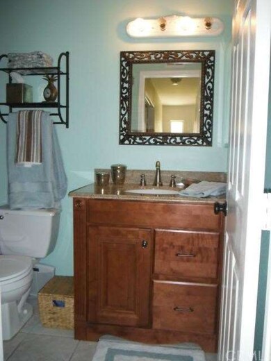 Upstairs bathroom features updated vanity and tile