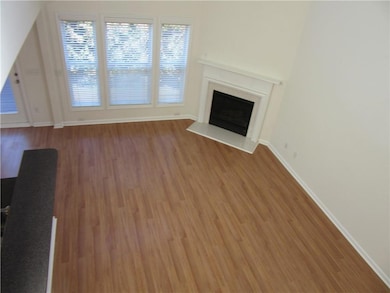 Unfurnished living room featuring light wood-style flooring and a fireplace