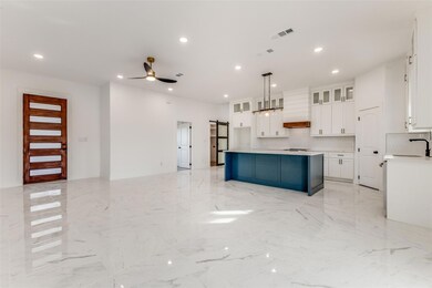 Kitchen featuring a barn door, visible vents, ceil