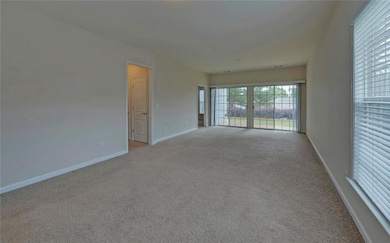 Spare room with carpet and baseboards