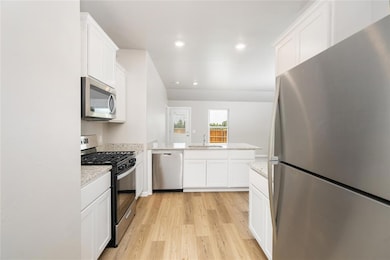 Modern white cabinetry and a full set of Whirlpool