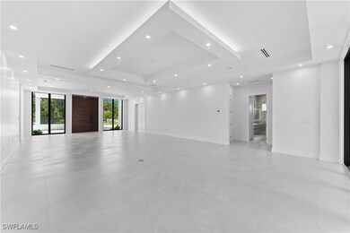 Empty room featuring a tray ceiling and expansive