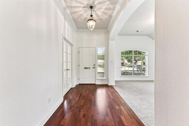 Foyer entrance with arched walkways, dark wood-st