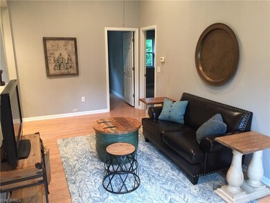 Vaulted Living room with wood laminate flooring.