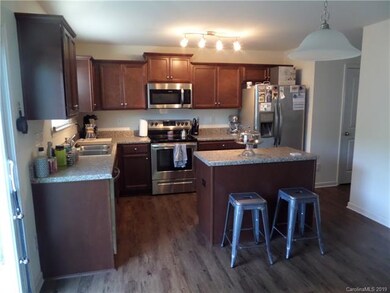 Kitchen with island and stainless steel appliances