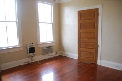 The light filled living room has high ceilings, or