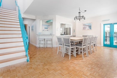 Dining room with stairs, a chandelier, and french doors