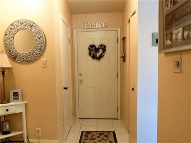 Welcoming Entry With Ceramic Tile and Convenient P