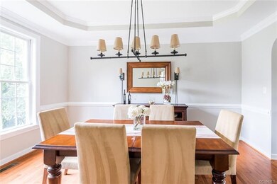 The dining room has hardwood flooring, crown and c