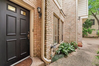 View of exterior entry featuring brick siding and