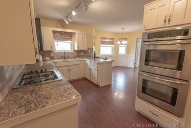 Double ovens and gas cooktop make this kitchen a c