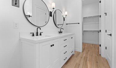 Primary bath features freestanding vanity with dual sinks