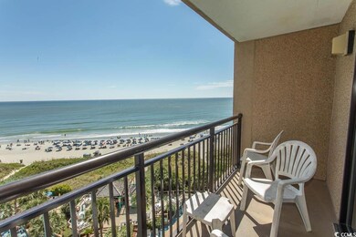 Balcony with view of water and beach