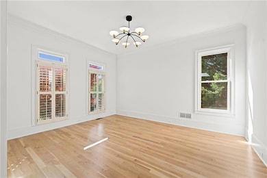Unfurnished dining area featuring a chandelier, li