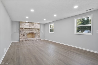 3740 Wilson Sharpsville Rd, Cortland, Ohio 44410 – Your dream home awaits! This stunning 5-bed, 3-bath single-family residence, completely renovated top-to-bottom, sits on a spacious 0.58-acre lot, blending luxury, functionality, and room to grow. Step into a bright, airy open-concept living space, perfect for modern living and effortless entertaining. The heart of the home is a gourmet kitchen featuring sleek Black Stainless Steel Samsung appliances, gorgeous Quartz Countertops, and an oversized island—ideal for meal prep, casual dining, or hosting. Enjoy abundant natural light through new windows and great installed lighting. Luxury LVT Shaw flooring flows seamlessly throughout, adding warmth and durability. Each of the three full bathrooms is beautifully updated with stylish finishes, offering a spa-like retreat.