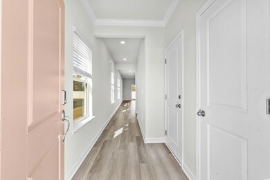 Hallway with light hardwood / wood-style flooring 