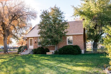 View of front of home with brick siding and a shingled roof