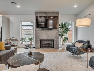 Living room with a fireplace, recessed lighting, and light wood-style floors
