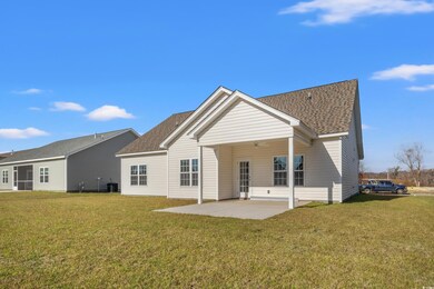 Back of house with a yard, a patio, and central AC