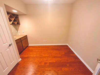Bar area featuring dark wood-style flooring and b